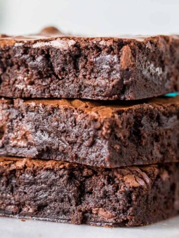 Three fudgy sourdough brownies stacked on top of each other.