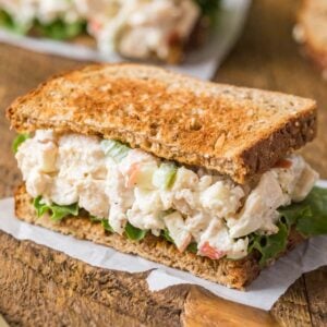 Chicken salad sandwich with lettuce and toasted wheat bread.