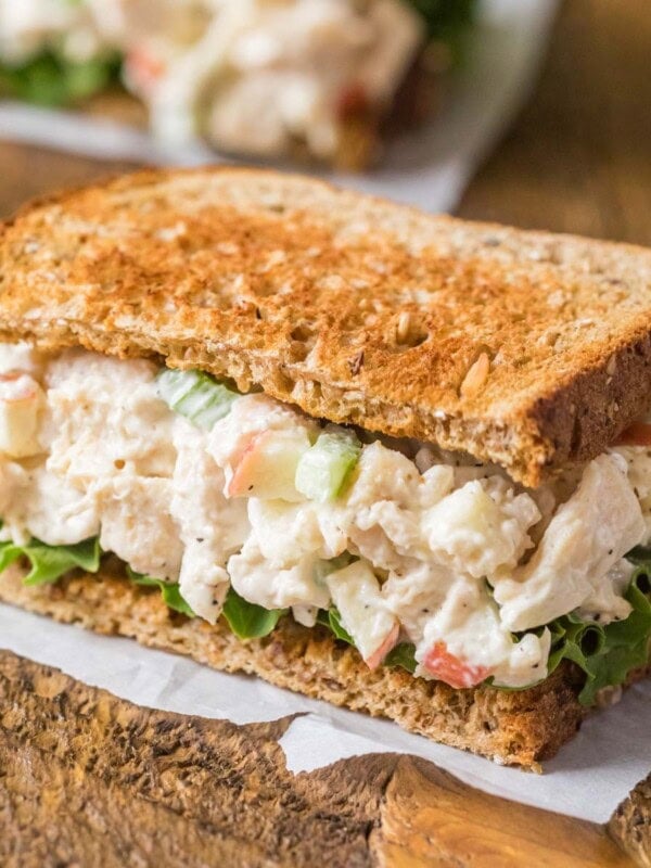 Chicken salad sandwich with lettuce and toasted wheat bread.