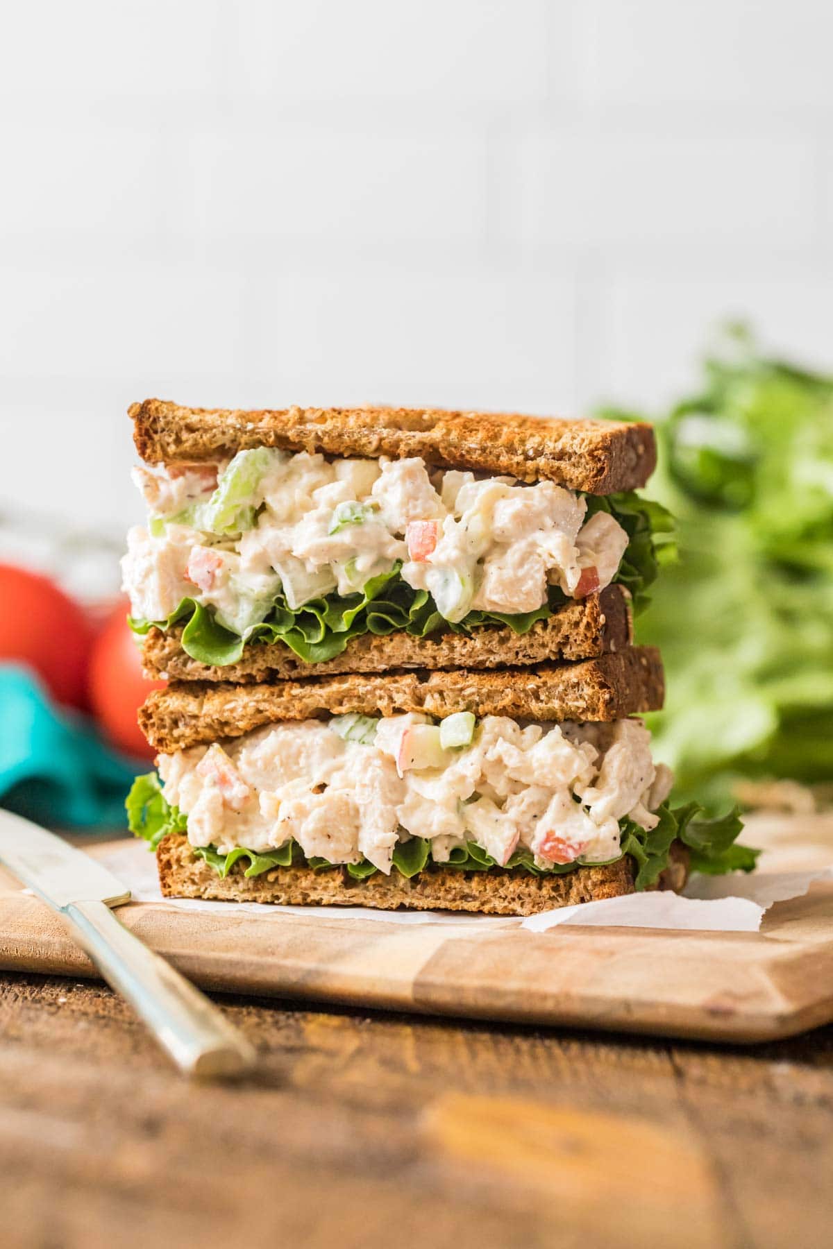 Chicken salad sandwich halves stacked on top of each other.