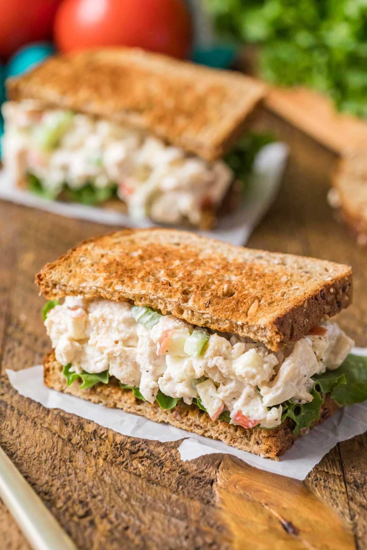 Chicken salad sandwich with lettuce and toasted wheat bread.