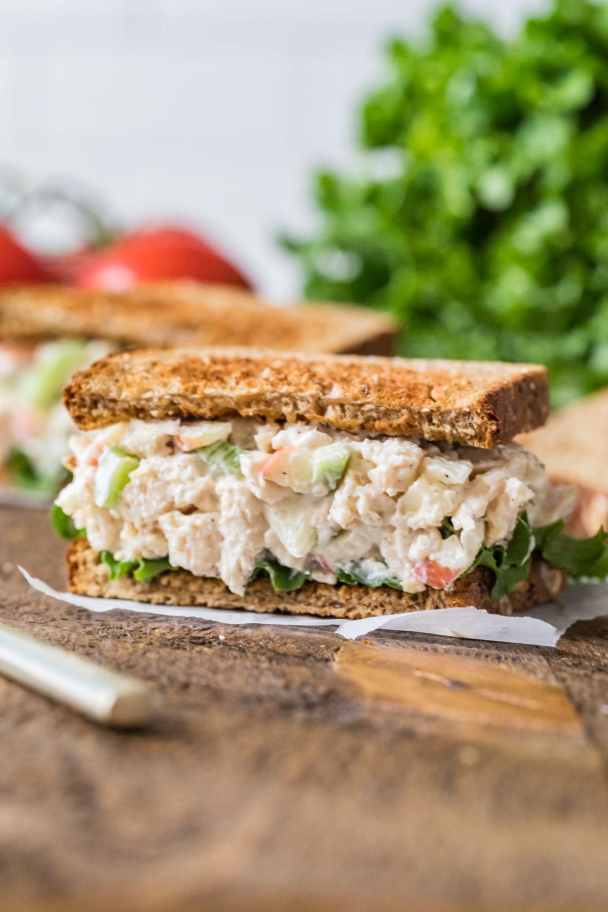 Salad made with chicken, mayo, apples, and more served on toasted wheat bread.