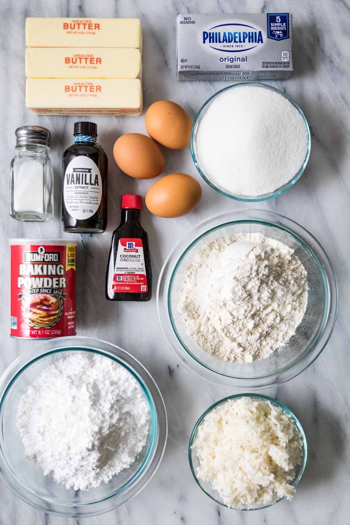 Overhead view of ingredients including coconut, cream cheese, butter, and more.