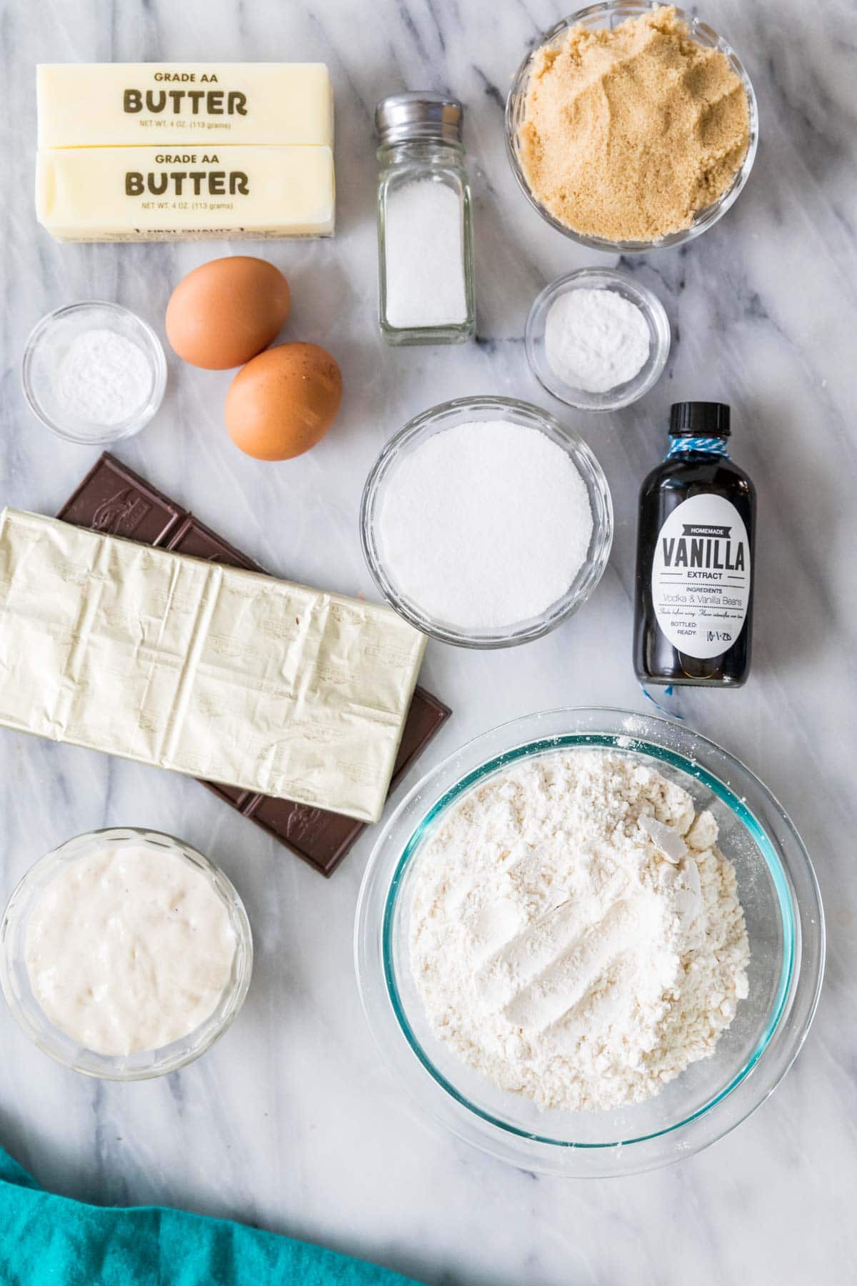 Overhead view of ingredients including butter, sourdough discard, eggs, chocolate bars, and more.