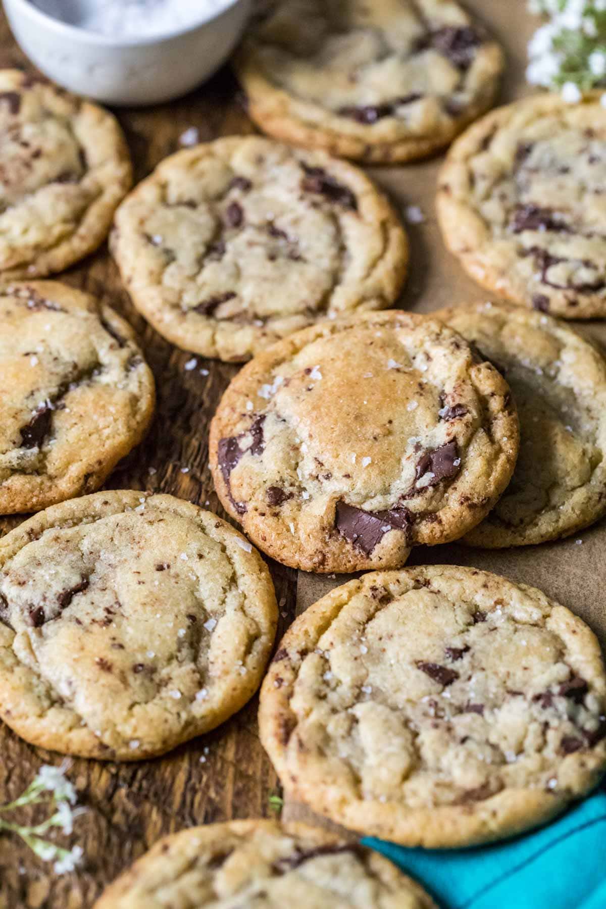 Sourdough discard chocolate chip cookies arranged over a wood surface.