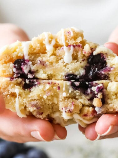Cross section of blueberry muffin cookies topped with streusel and glaze.