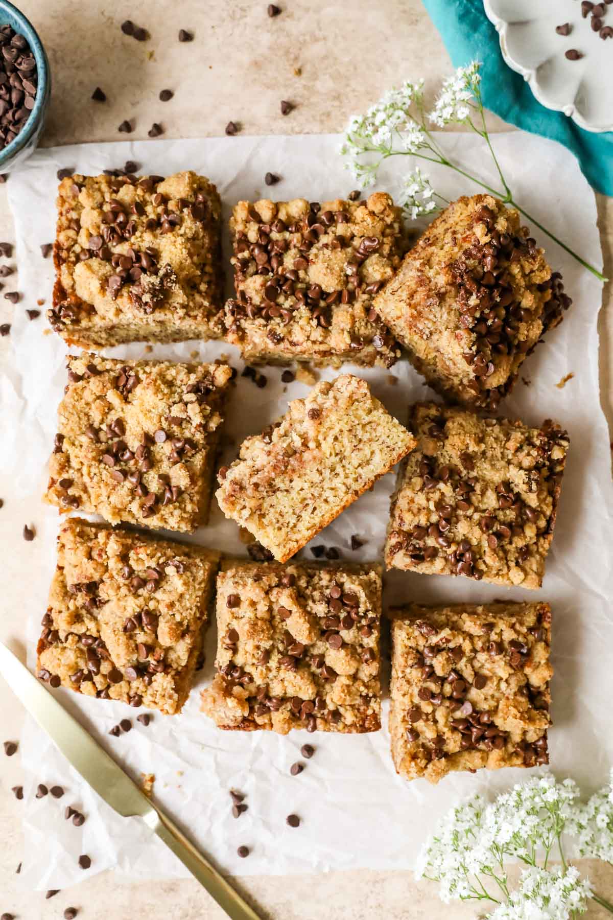 Overhead view of a banana coffee cake that's been removed from the pan and cut into square pieces.