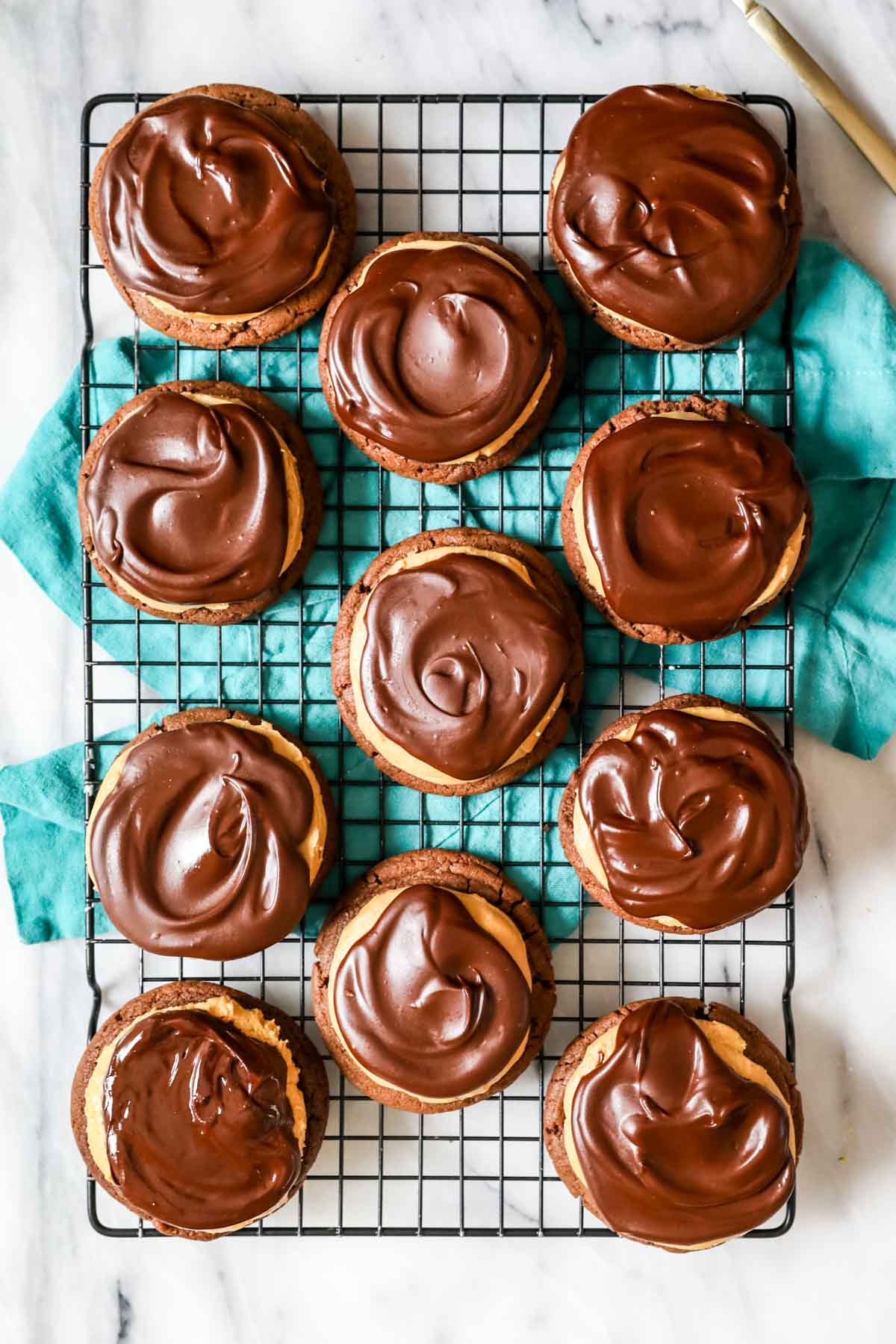 Overhead view of a cooling rack of buckeye cookies.