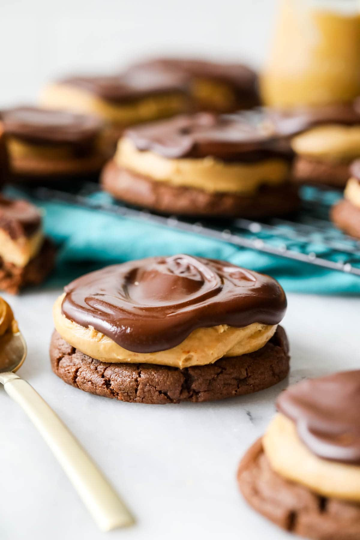 Buckeye cookie consisting of a chocolate cookie topped with peanut butter and chocolate.