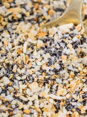 Close-up shot of everything bagel seasoning being scooped with a spoon.