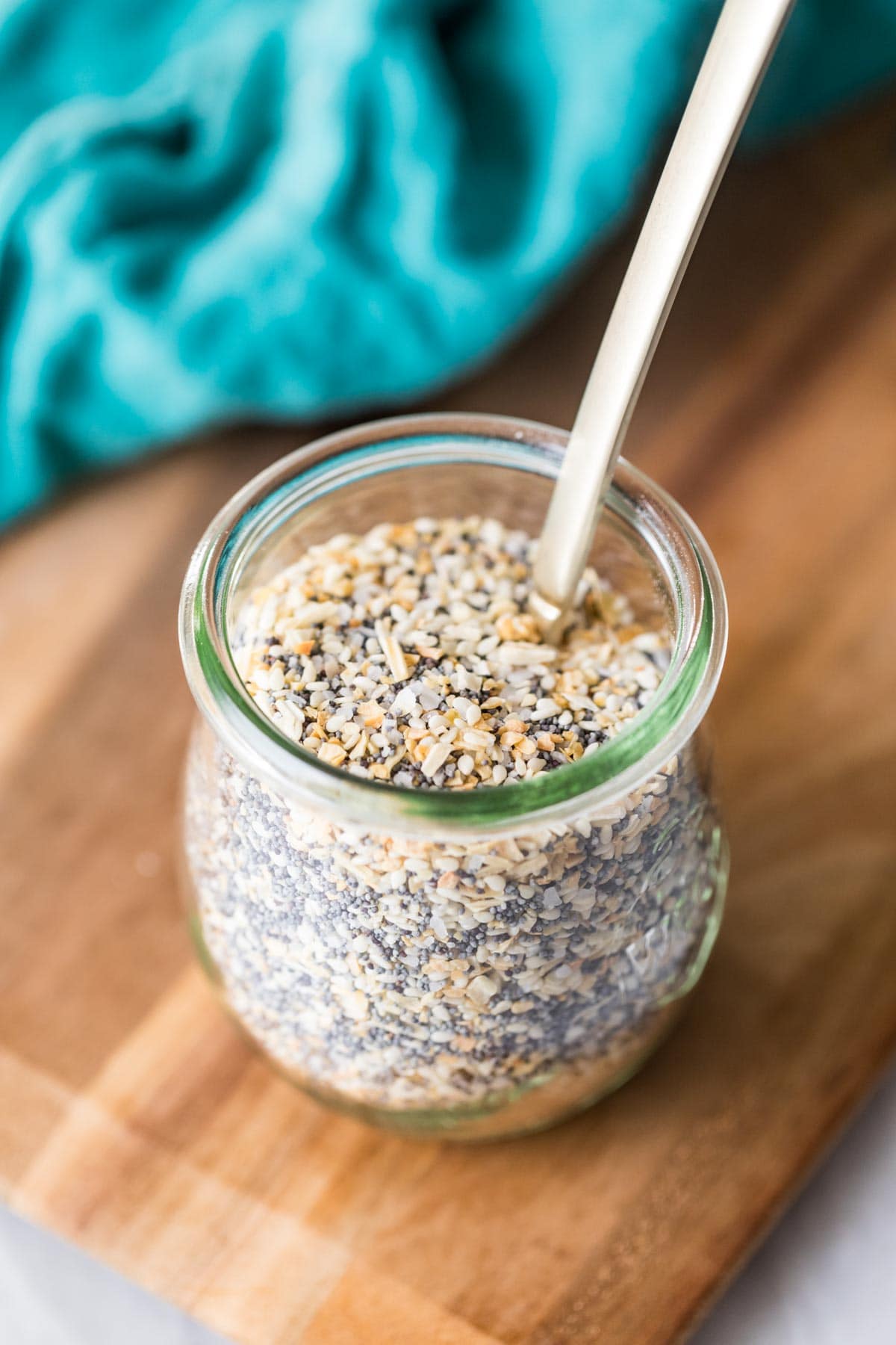 Overhead view of a small glass jar of homemade everything bagel seasoning.