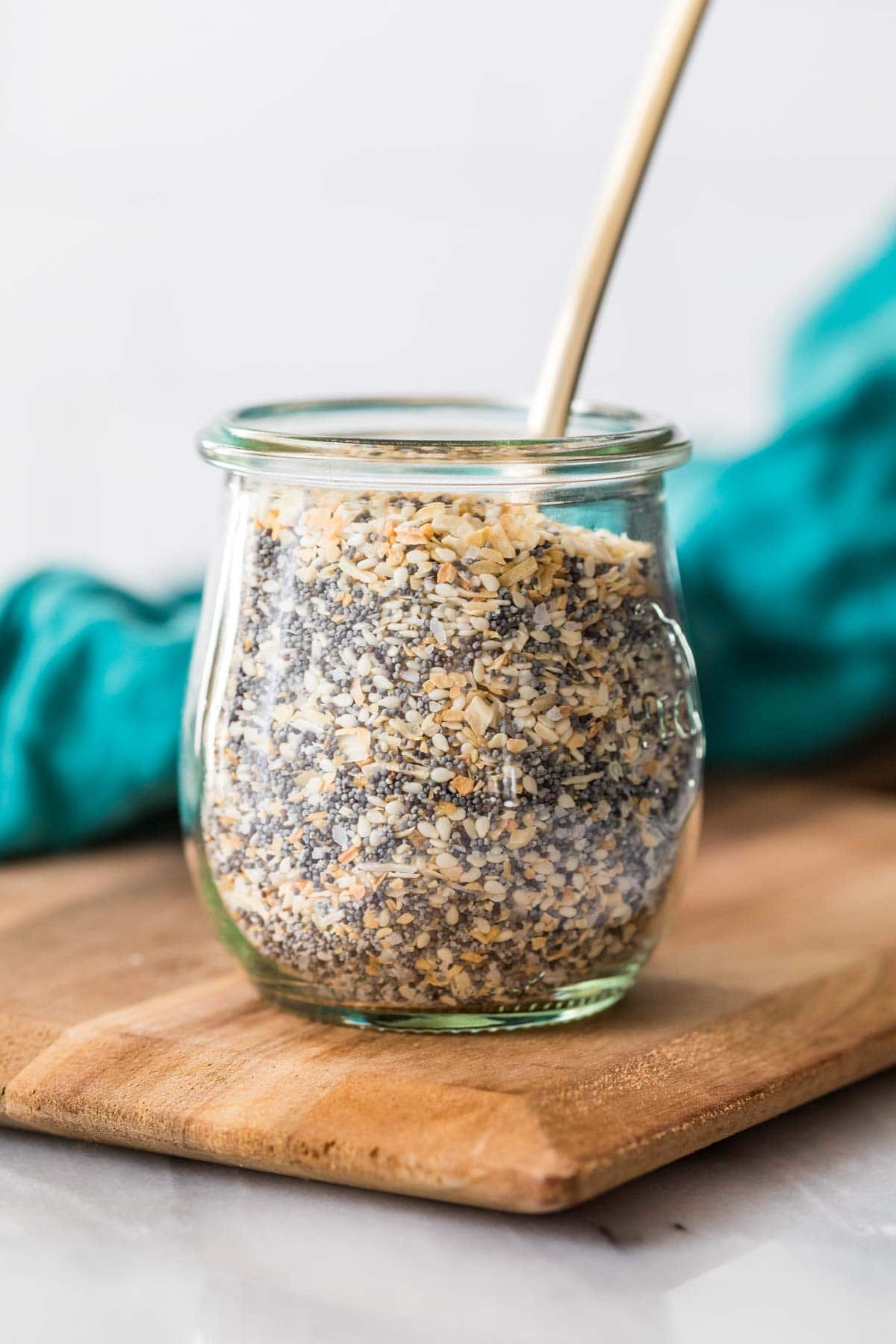 Head on view of a glass jar filled with a homemade seasoning for everything bagels.