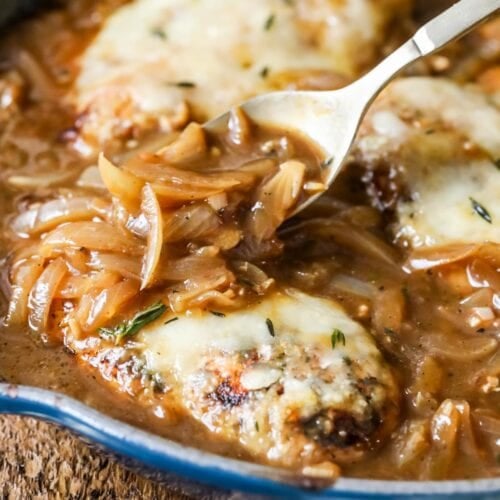 Caramelized onion gravy being spooned over french onion chicken.
