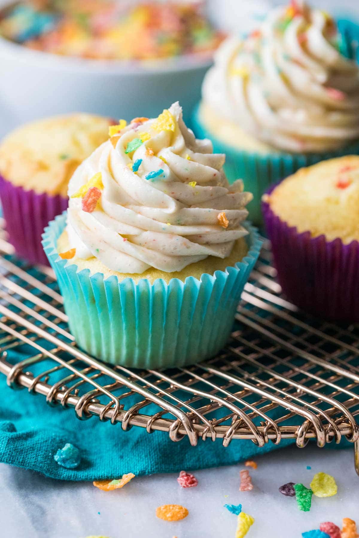 Vanilla cupcake frosted with a piped fruity pebbles frosting.