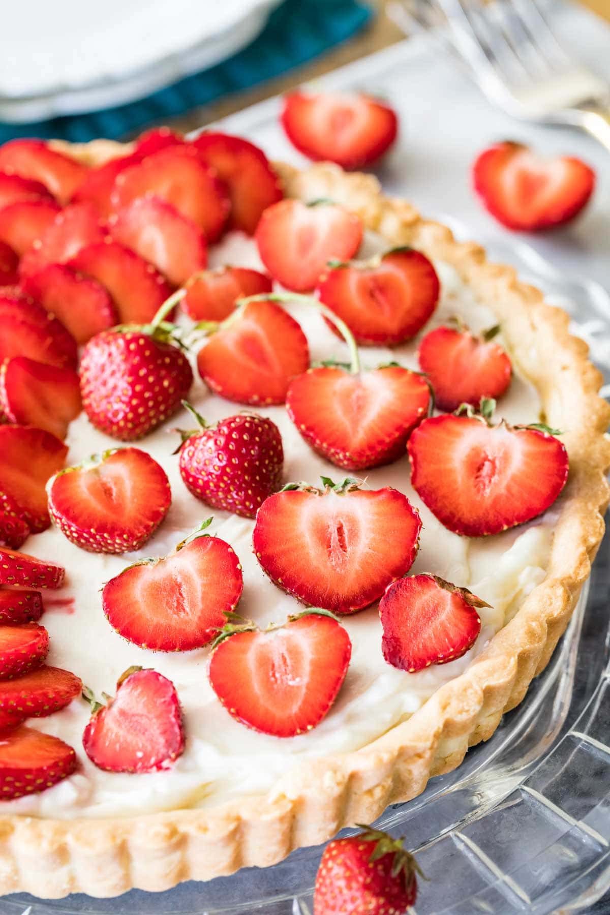 Close-up view of strawberry halves on top of a tart.