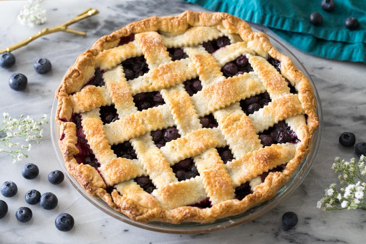 Overhead view of a whole blueberry pie with a lattice crust.
