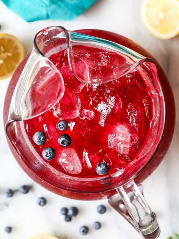 Overhead view of a pitcher of blueberry lemonade.