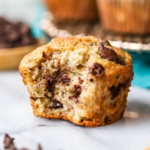 Chocolate chip banana muffin with one bite missing.