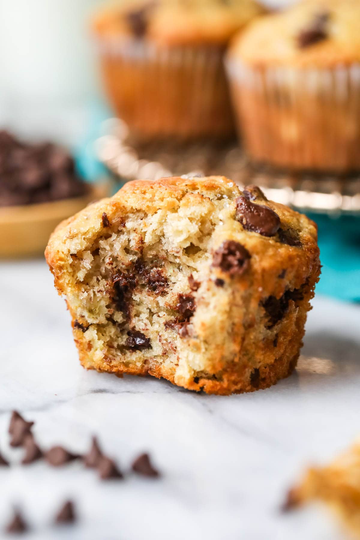 Chocolate chip banana muffin with one bite missing.
