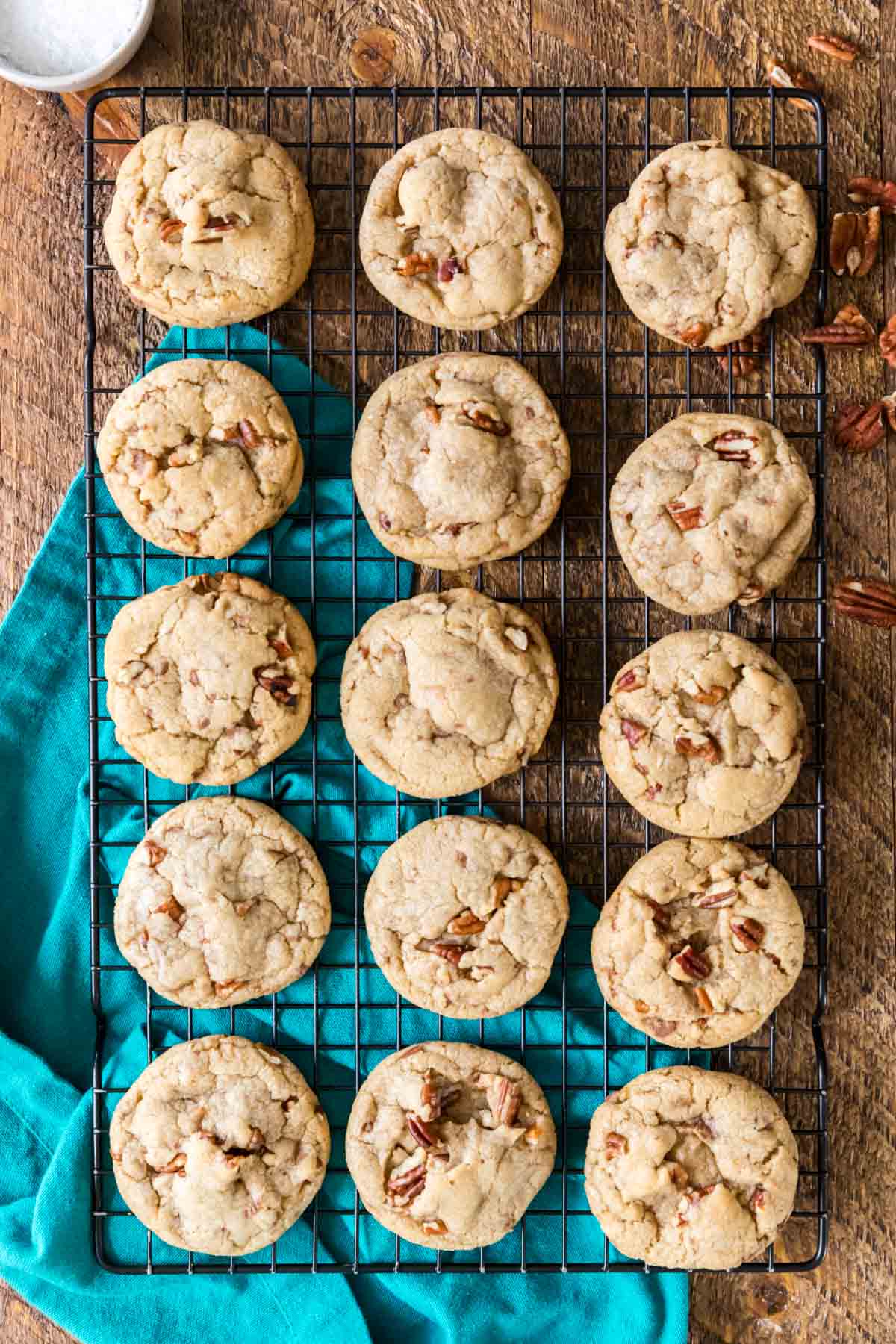 Overhead view of a cooling rack of cookies made with pecans.