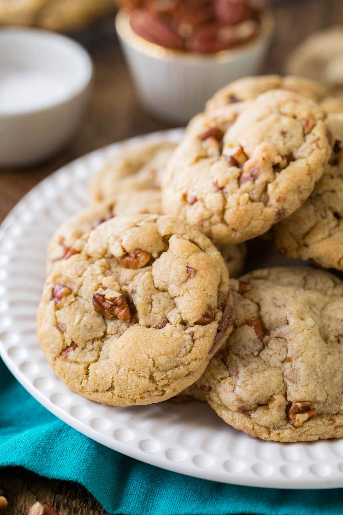 Butter pecan cookies piled onto a white plate.