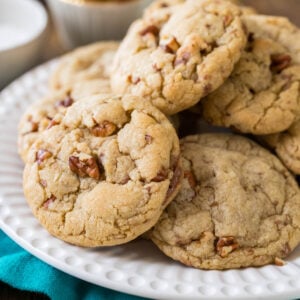 Butter pecan cookies piled onto a white plate.