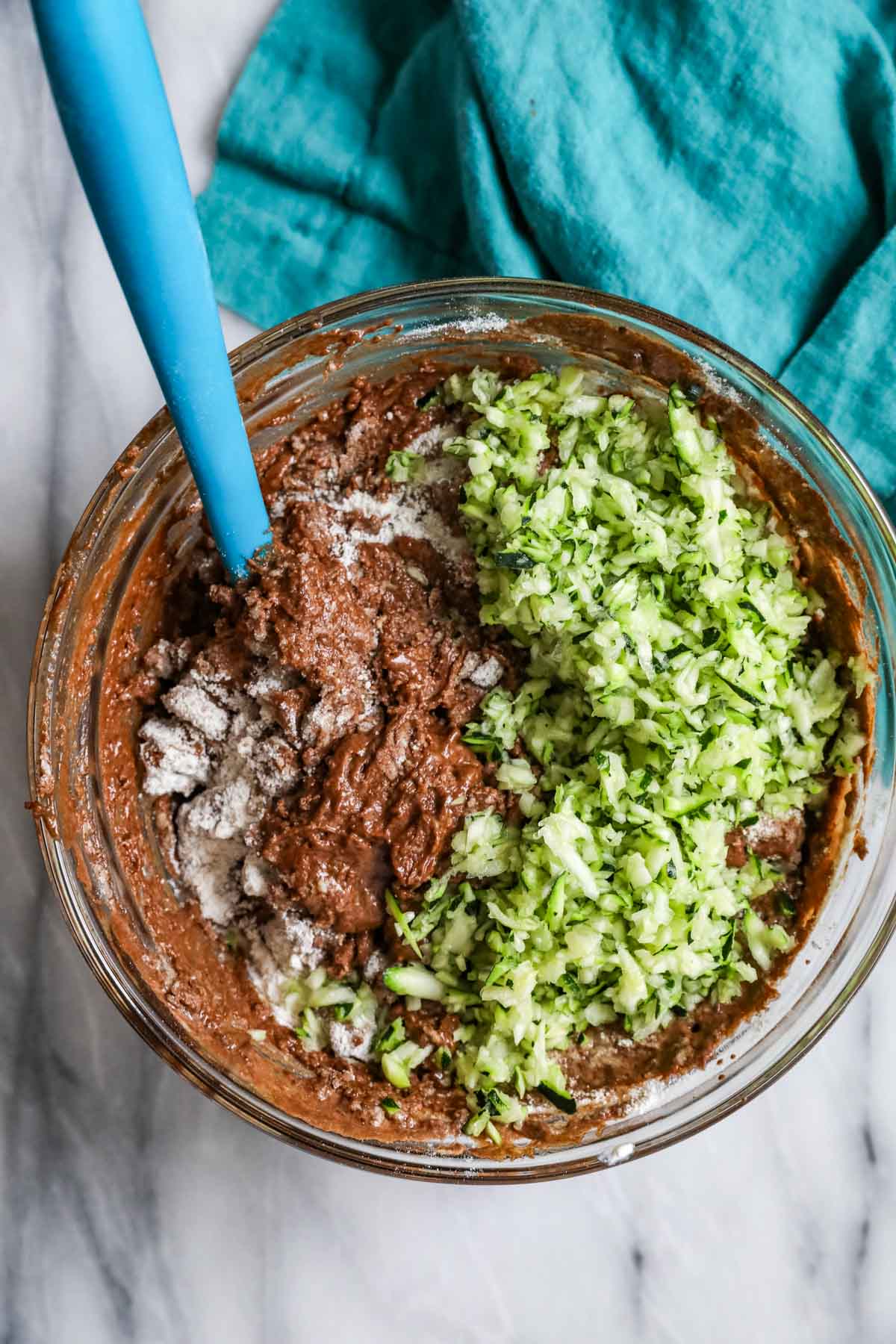mixing shredded zucchini into chocolate batter