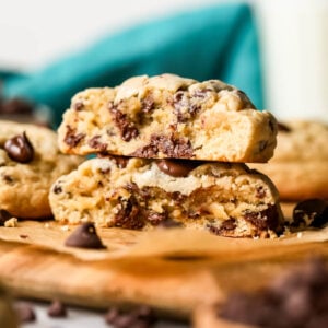 Two halves of thick chocolate chip cookies stacked on top of each other.