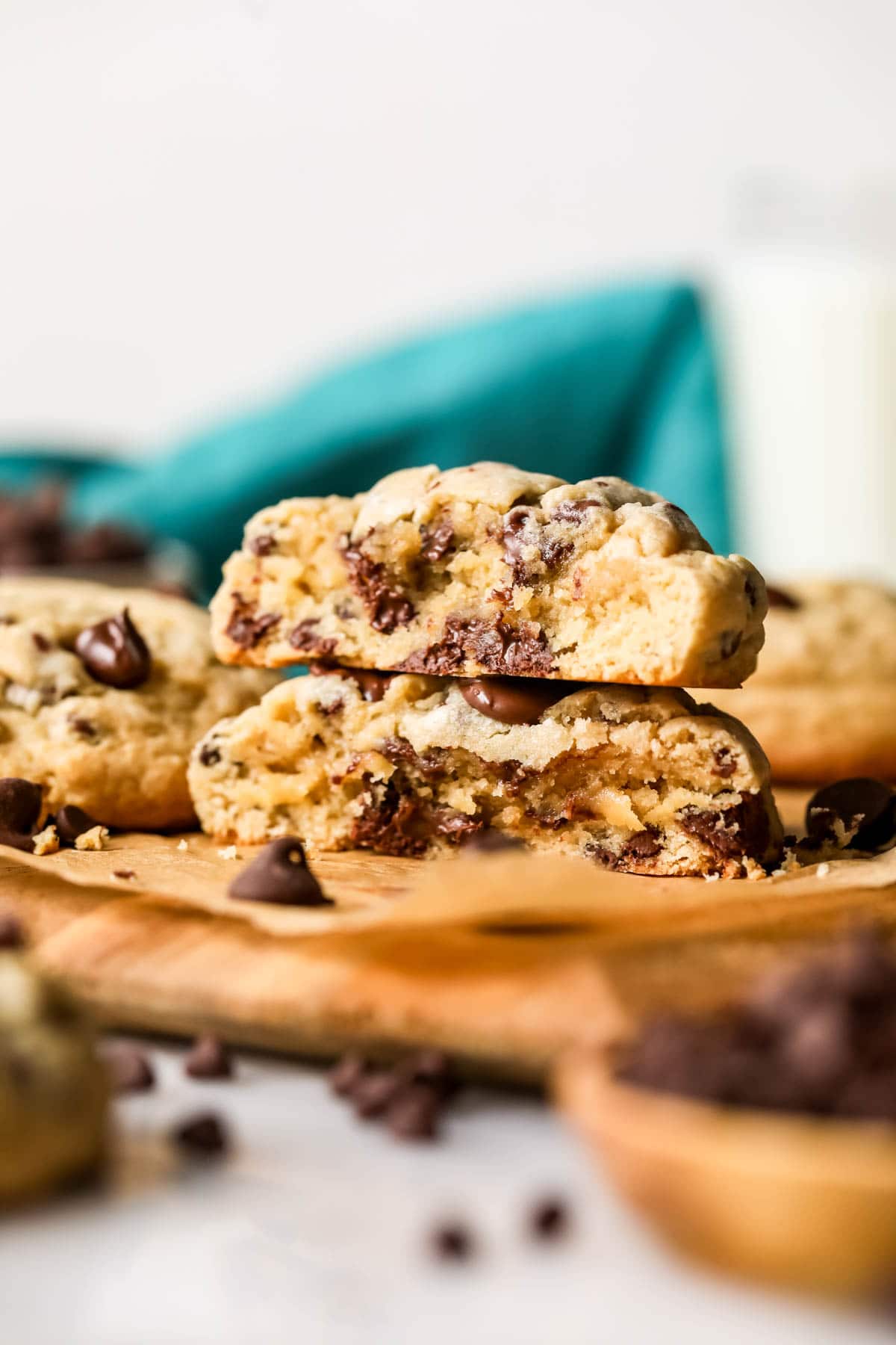 Two halves of thick chocolate chip cookies stacked on top of each other.