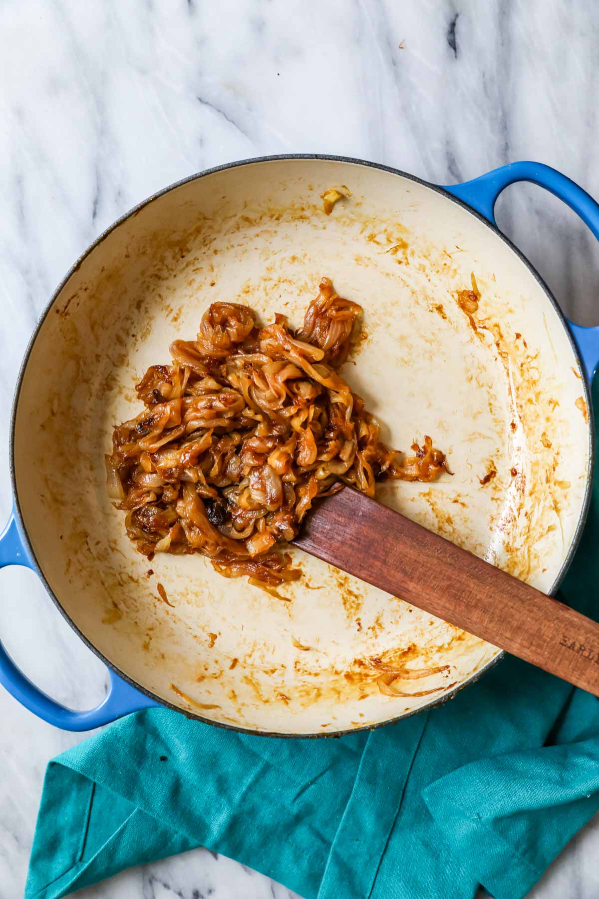 Overhead view of golden cooked caramelized onions in a pan