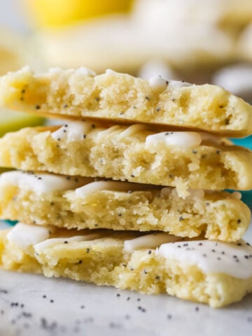 Four halves of a lemon poppy seed cookies stacked on top of each other.