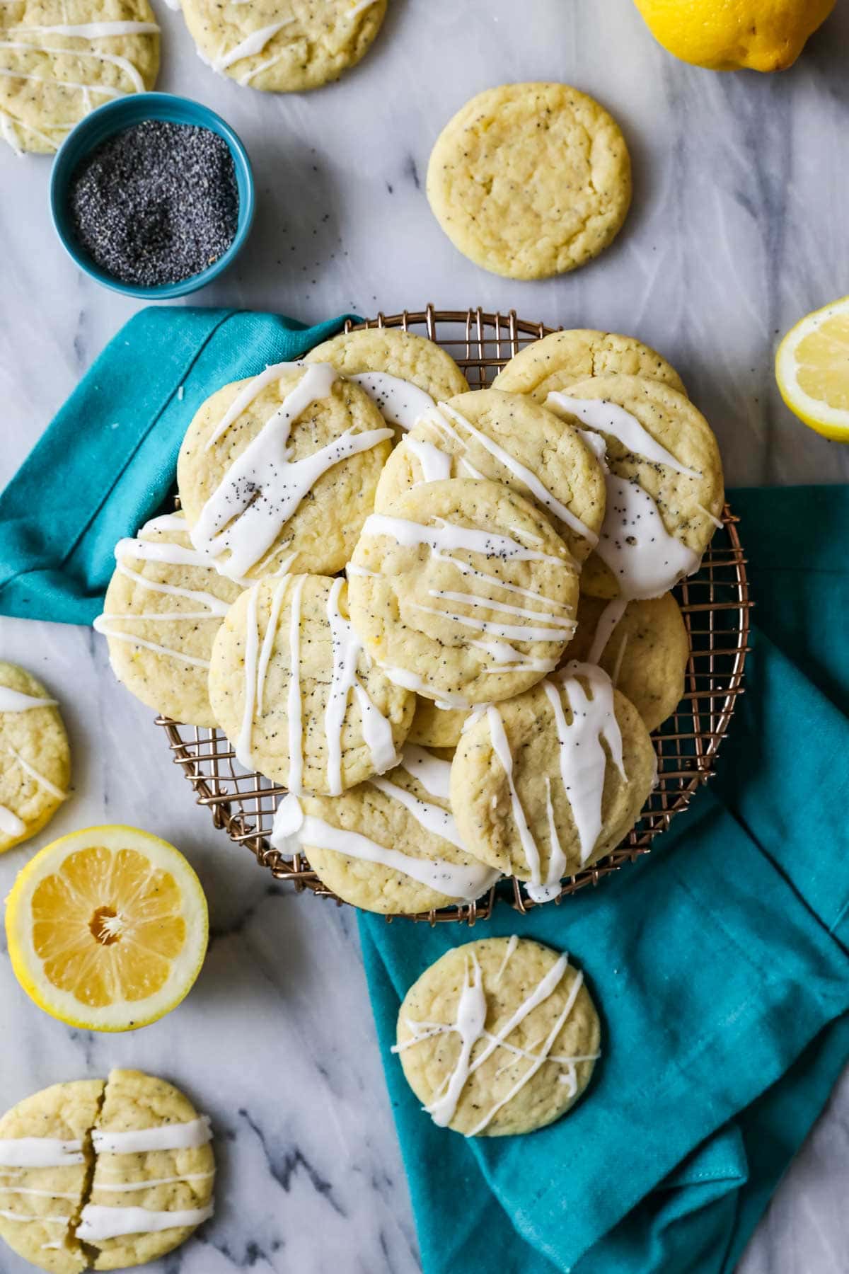Overhead view of a pile of lemon cookies drizzled with glaze.