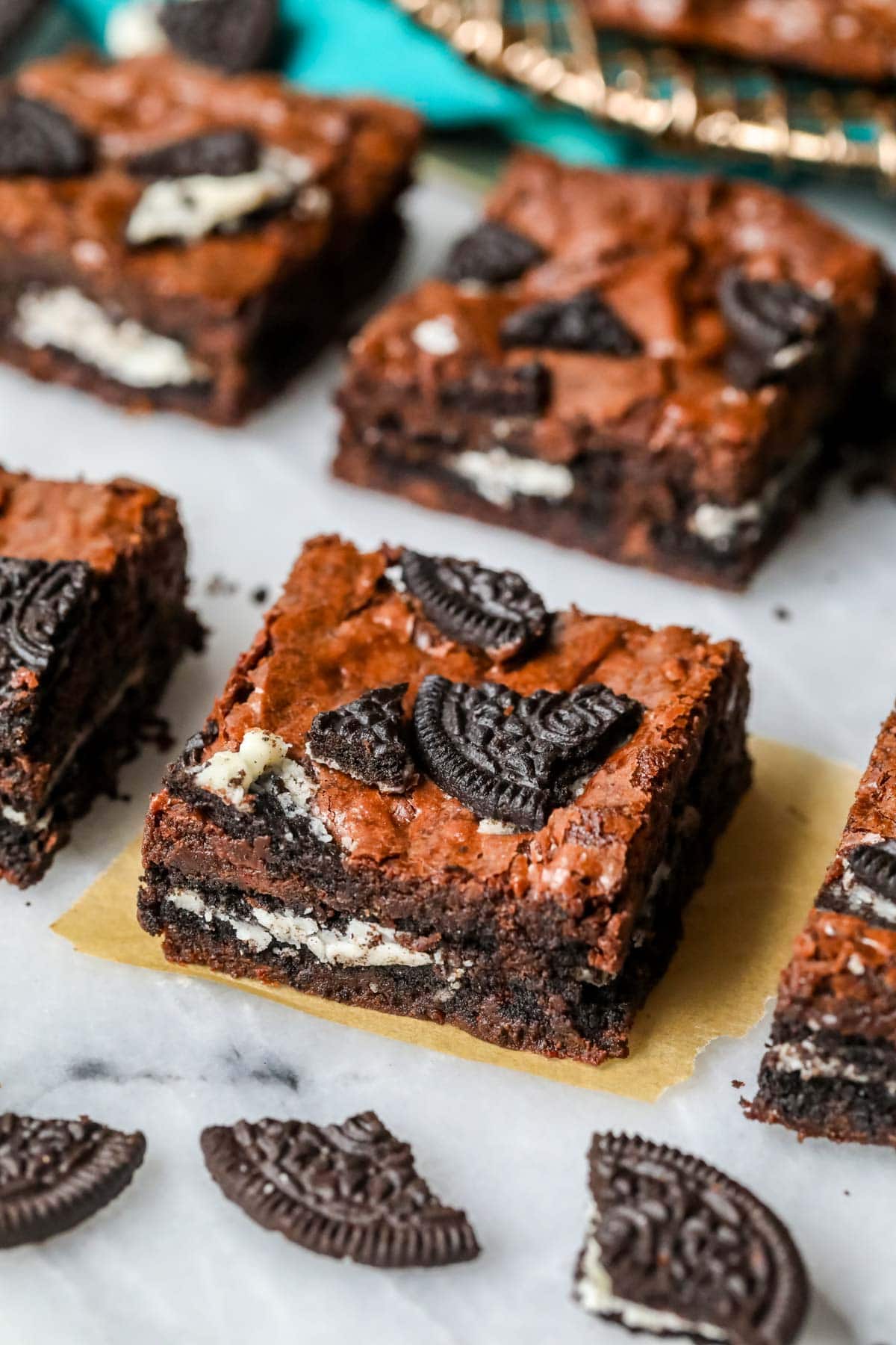 Rows of square cut brownies made with Oreos in the middle and on top.