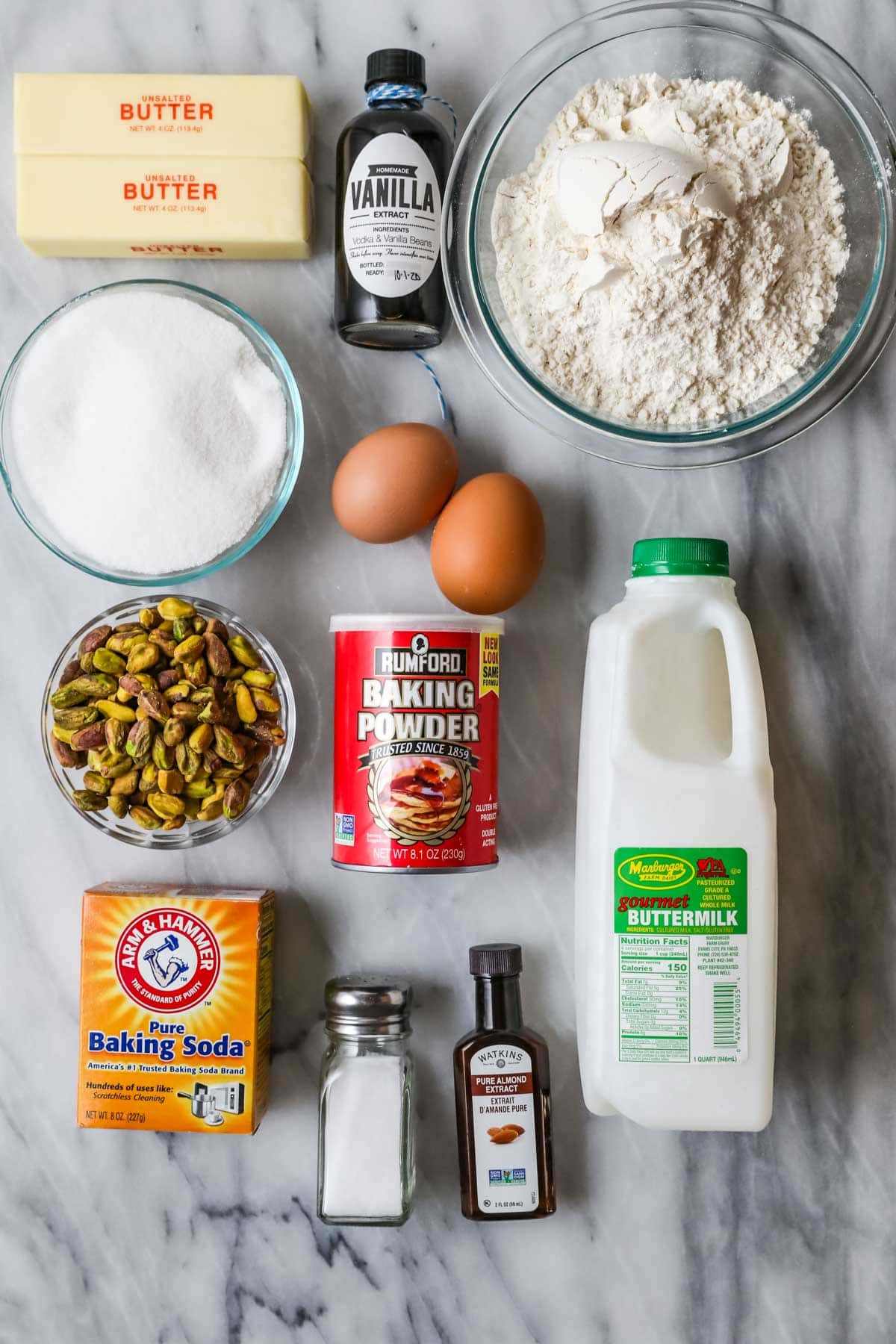 Overhead view of ingredients including buttermilk, pistachios, almond extract, and more.