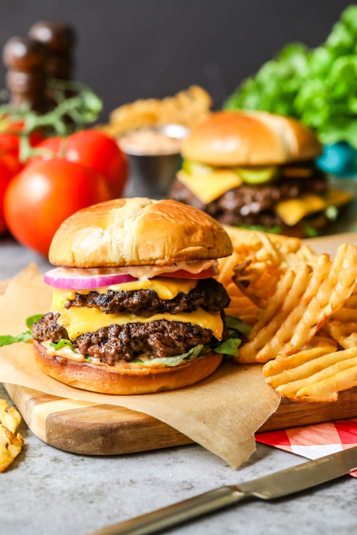 Homemade smash burger with a side of waffle fries.