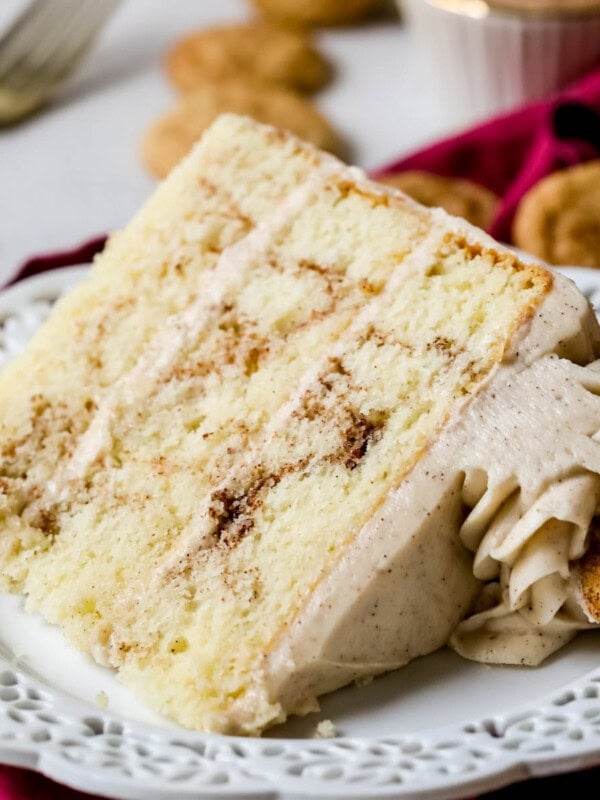 Slice of snickerdoodle cake on a white plate.