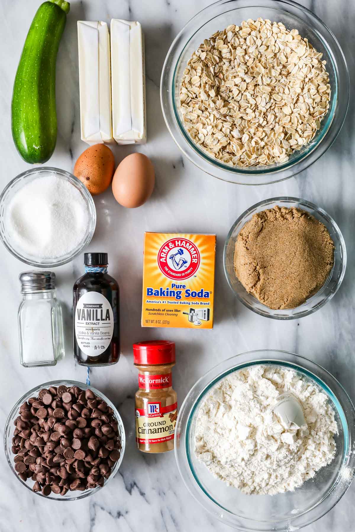 Overhead view of ingredients including zucchini, oatmeal, brown sugar, and more.