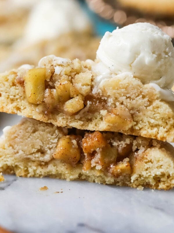 Two halves of an apple pie cookie stacked on top of each other.