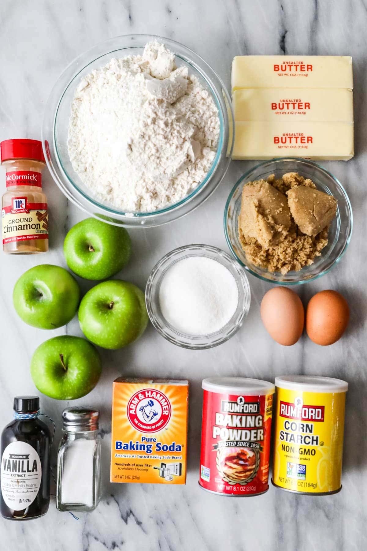 Overhead view of ingredients including apples, brown sugar, butter, and more.
