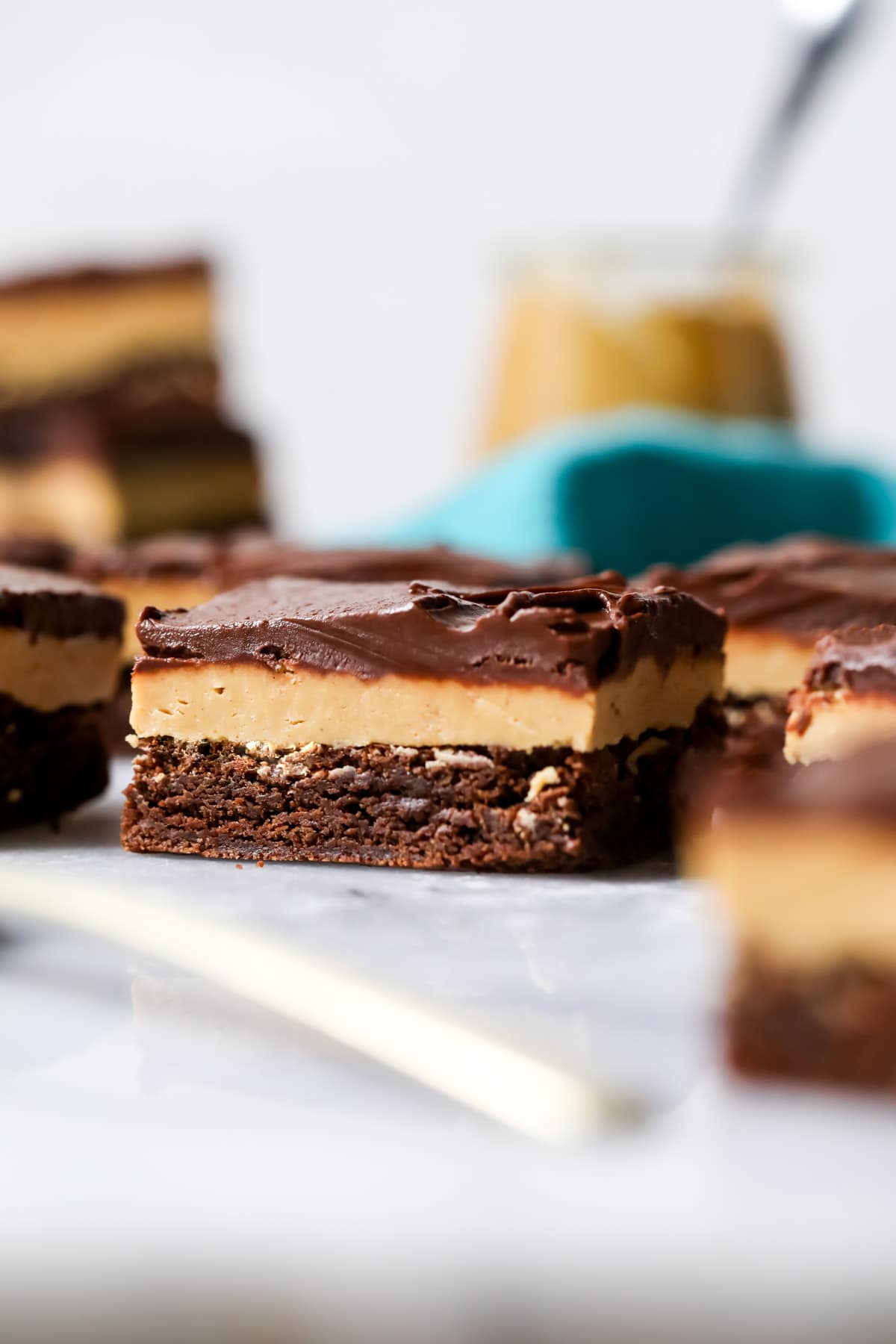 Brownie with a layer of peanut butter fudge and chocolate on top.