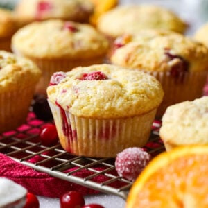 Cranberry orange muffins on a cooling rack.