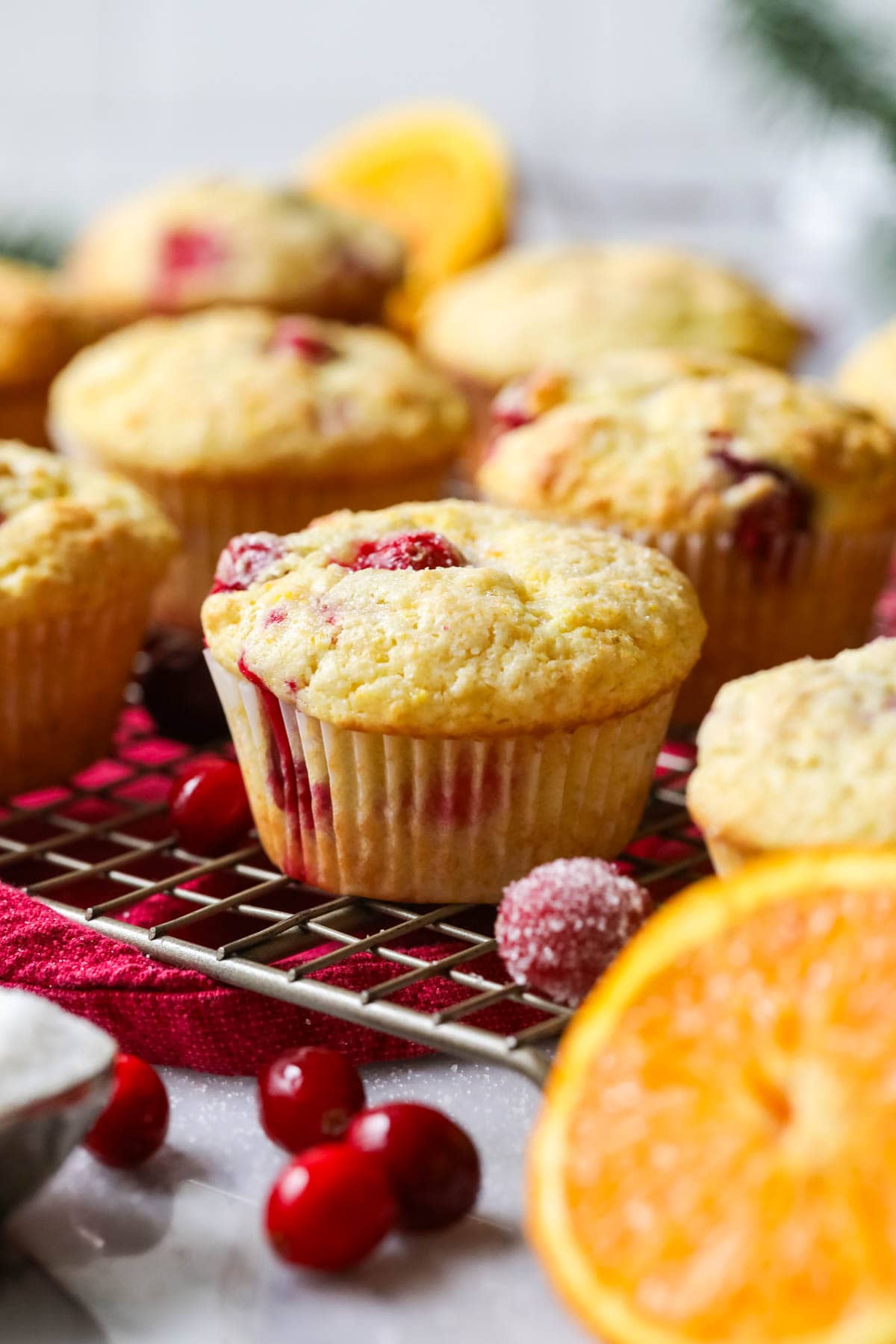 Cranberry orange muffins on a cooling rack.