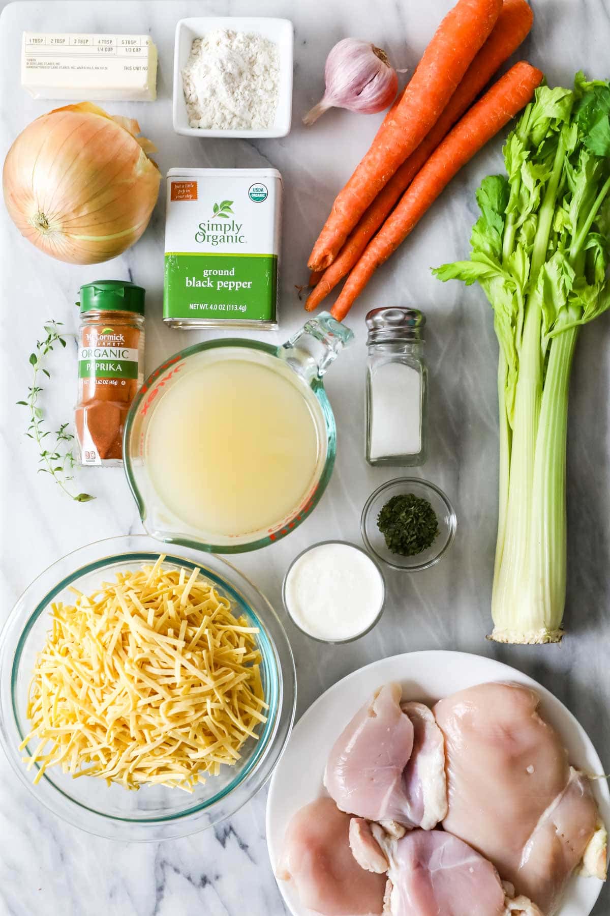 Overhead view of ingredients including carrots, celery, chicken, and more.