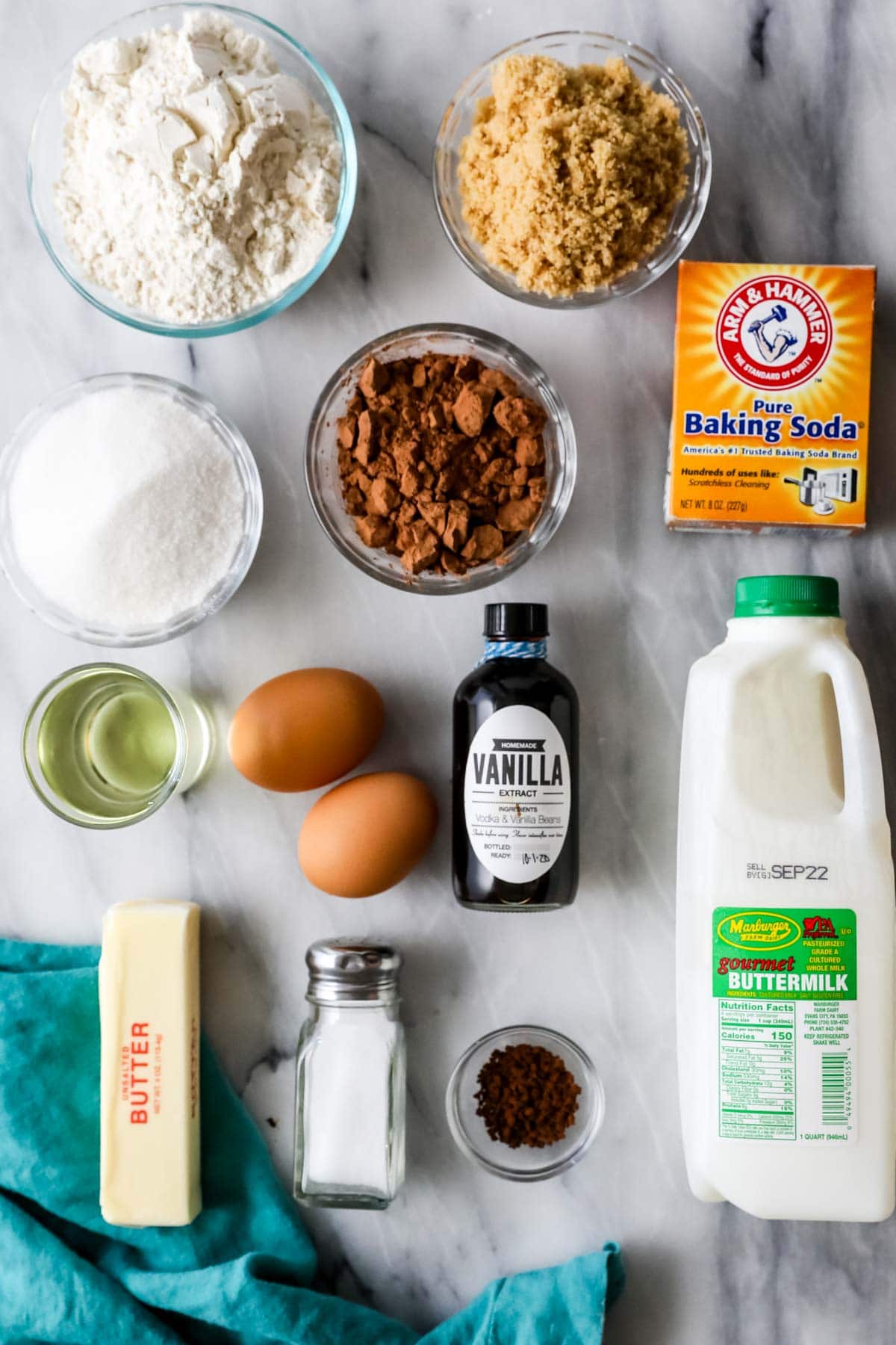 Overhead view of ingredients including buttermilk, cocoa powder, brown sugar, and more.