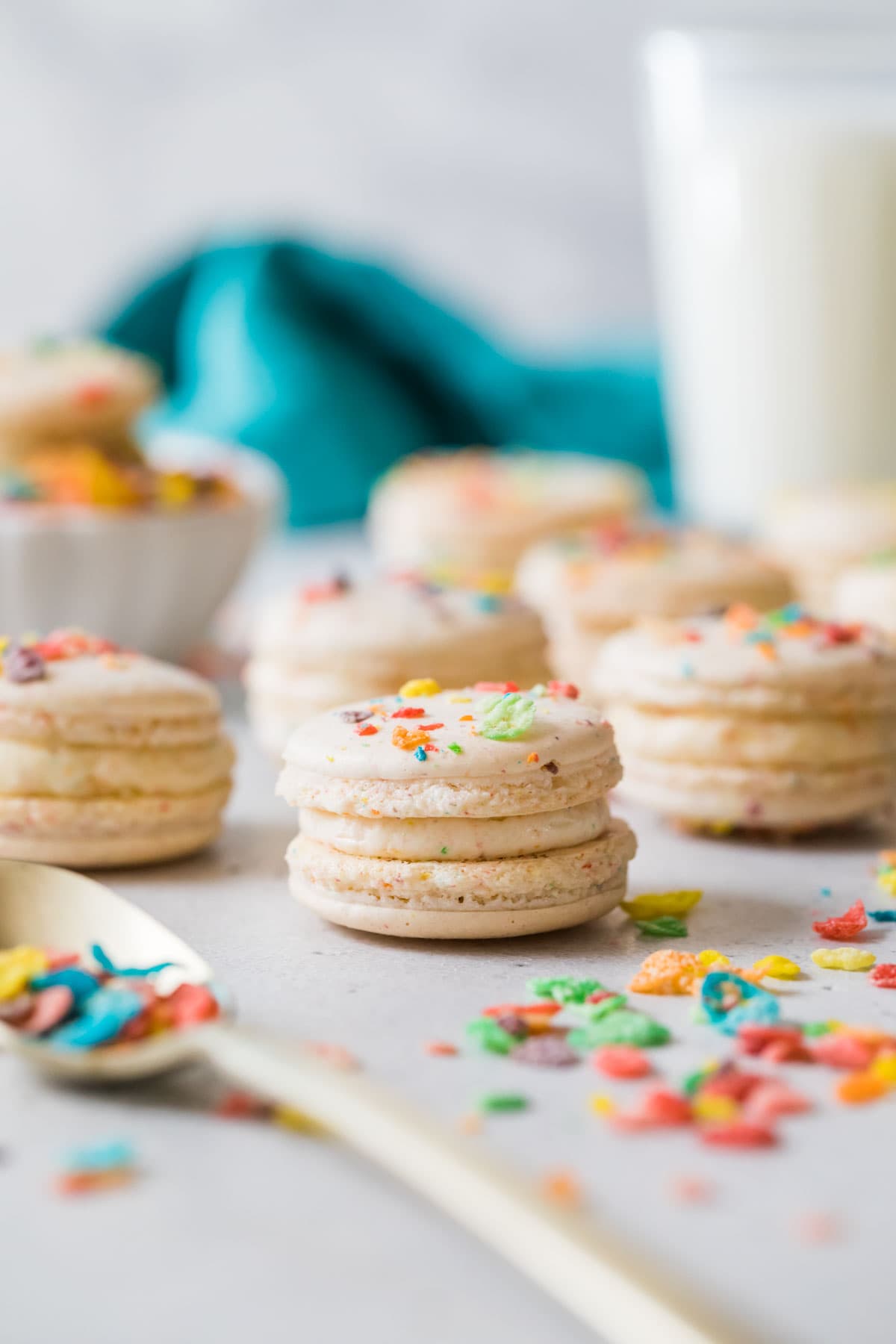 Fruity pebble macarons on a white countertop.