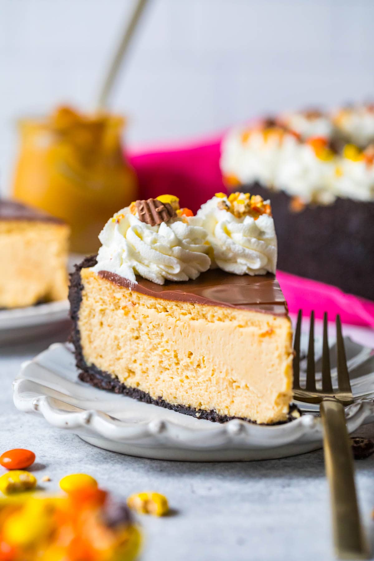 Slice of peanut butter cheesecake on a white plate.