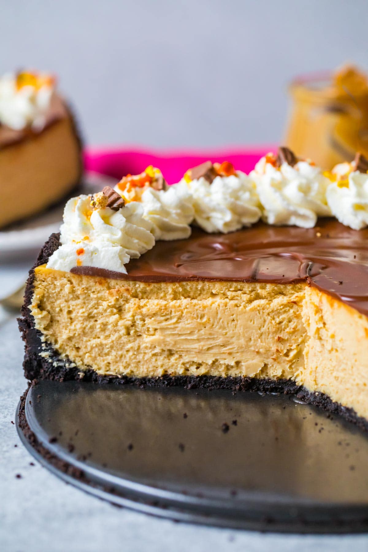 Cross section of a cheesecake made with peanut butter and chocolate ganache on an Oreo crust.