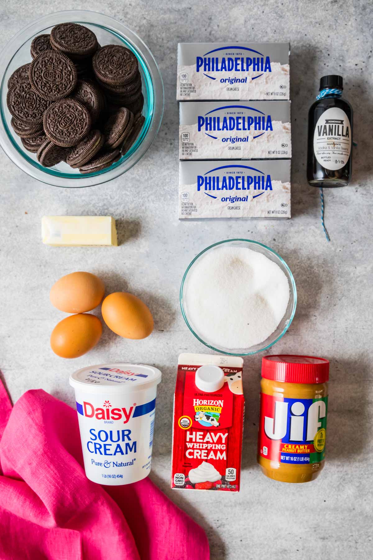 Overhead view of ingredients including Oreos, peanut butter, sour cream, heavy cream, and more.