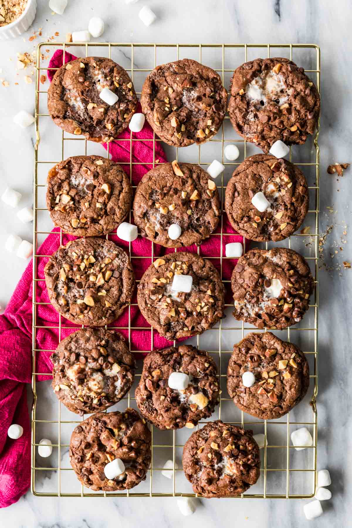 Rocky road cookies arranged in rows on a cooling rack.