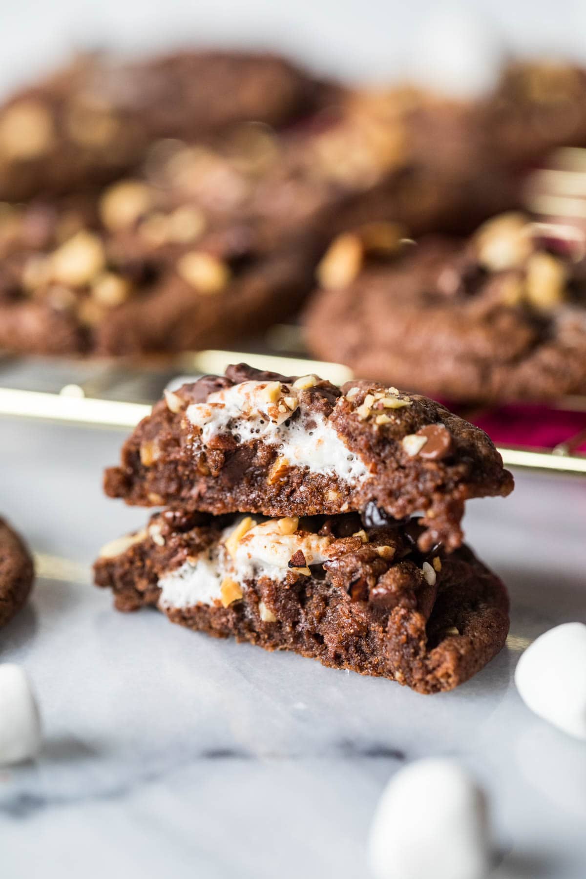 Two halves of a rocky road cookie stacked on top of each other.
